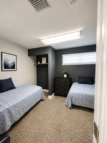 Two-bed room with dark accent wall